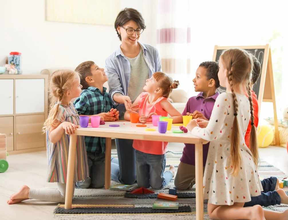 teacher and children playing with playdough in classroom.jpg